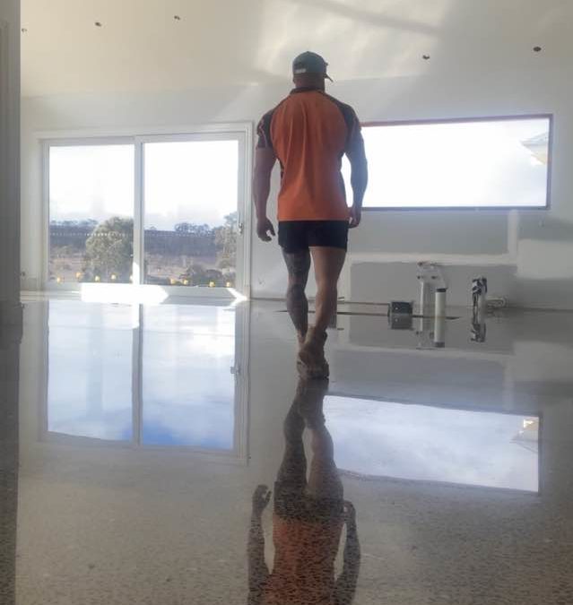 A satisfied tradesman “reflecting” on the quality of his finish - “ Full Aggregate exposed Decorative Hyperfloor Polished Concrete. “ .Allergen free, hard wearing, easy to maintain and visually stunning.